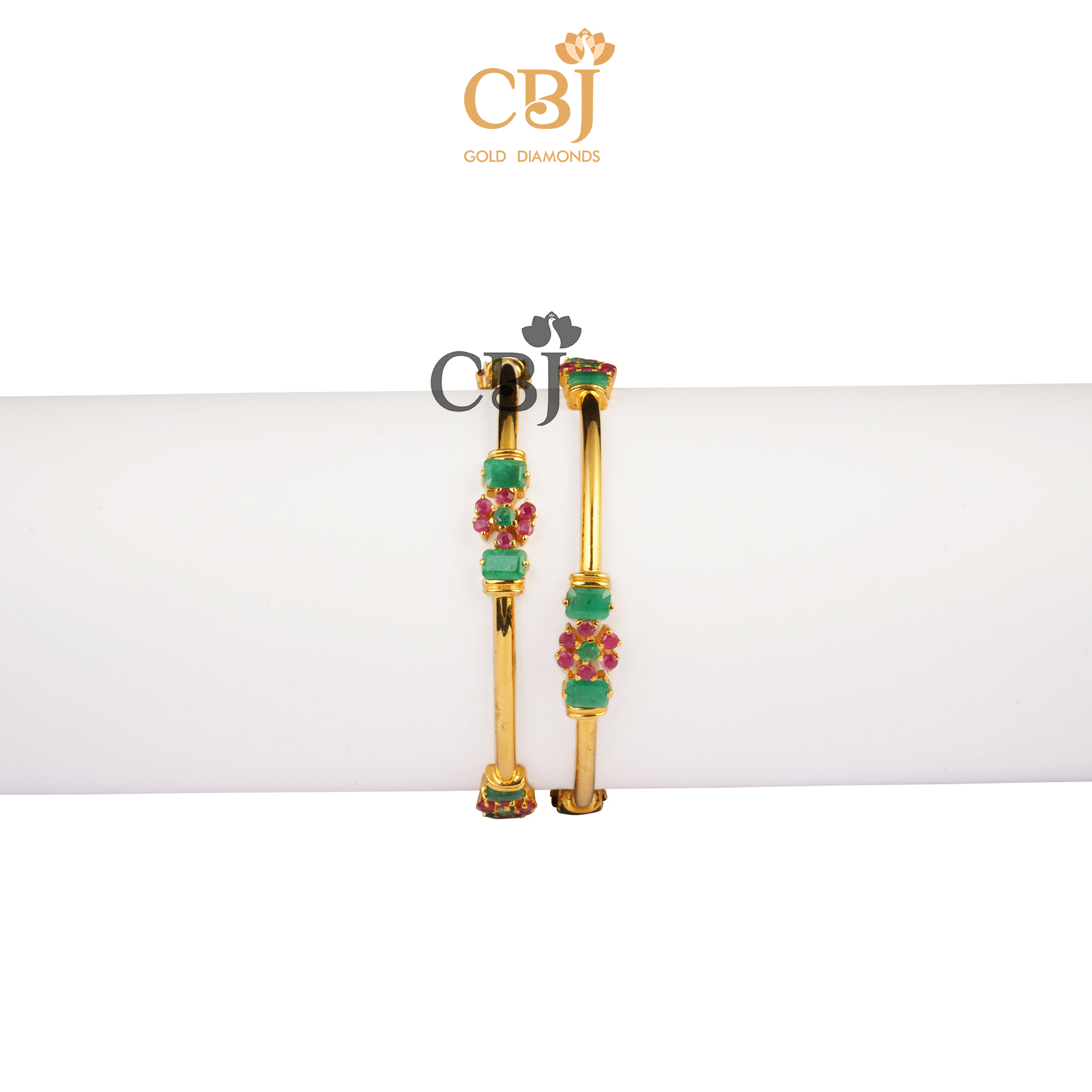 Flat bangles featuring a combination of ruby and emerald stones.