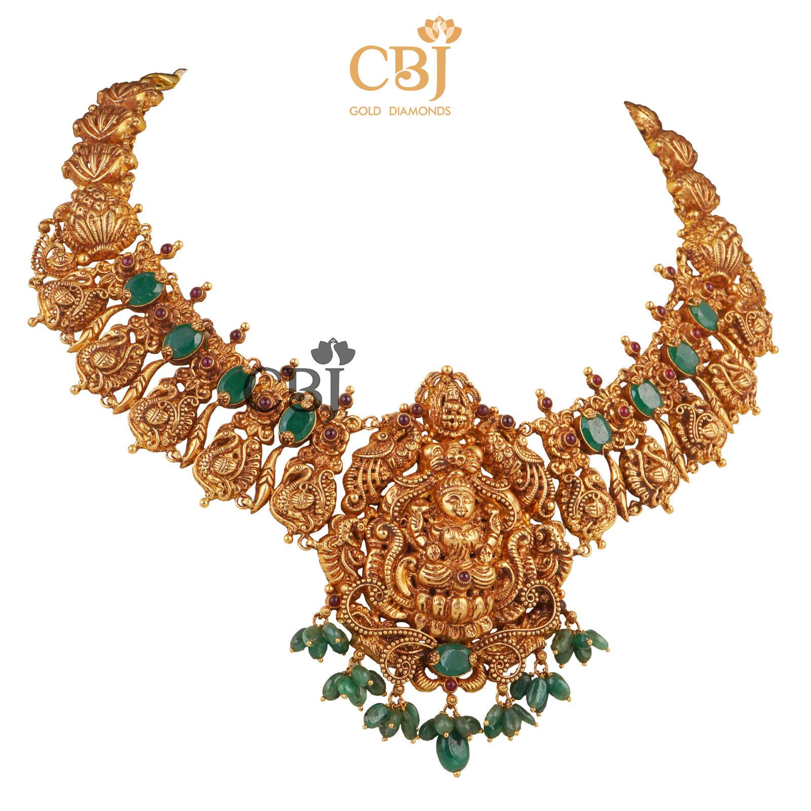 A luxurious Lakshmi nakas necklace studded with emerald stones.