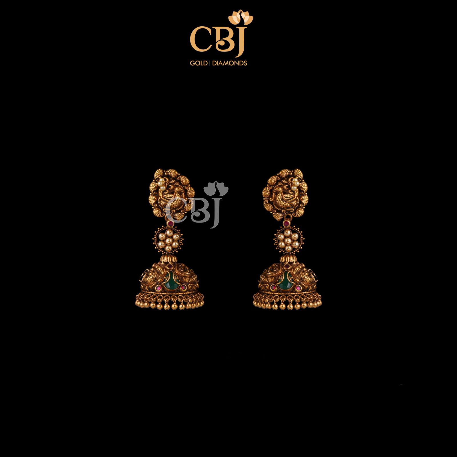 A subtle traditional design that highlights the motifs. Antique designer jhumkas are quite the trend.