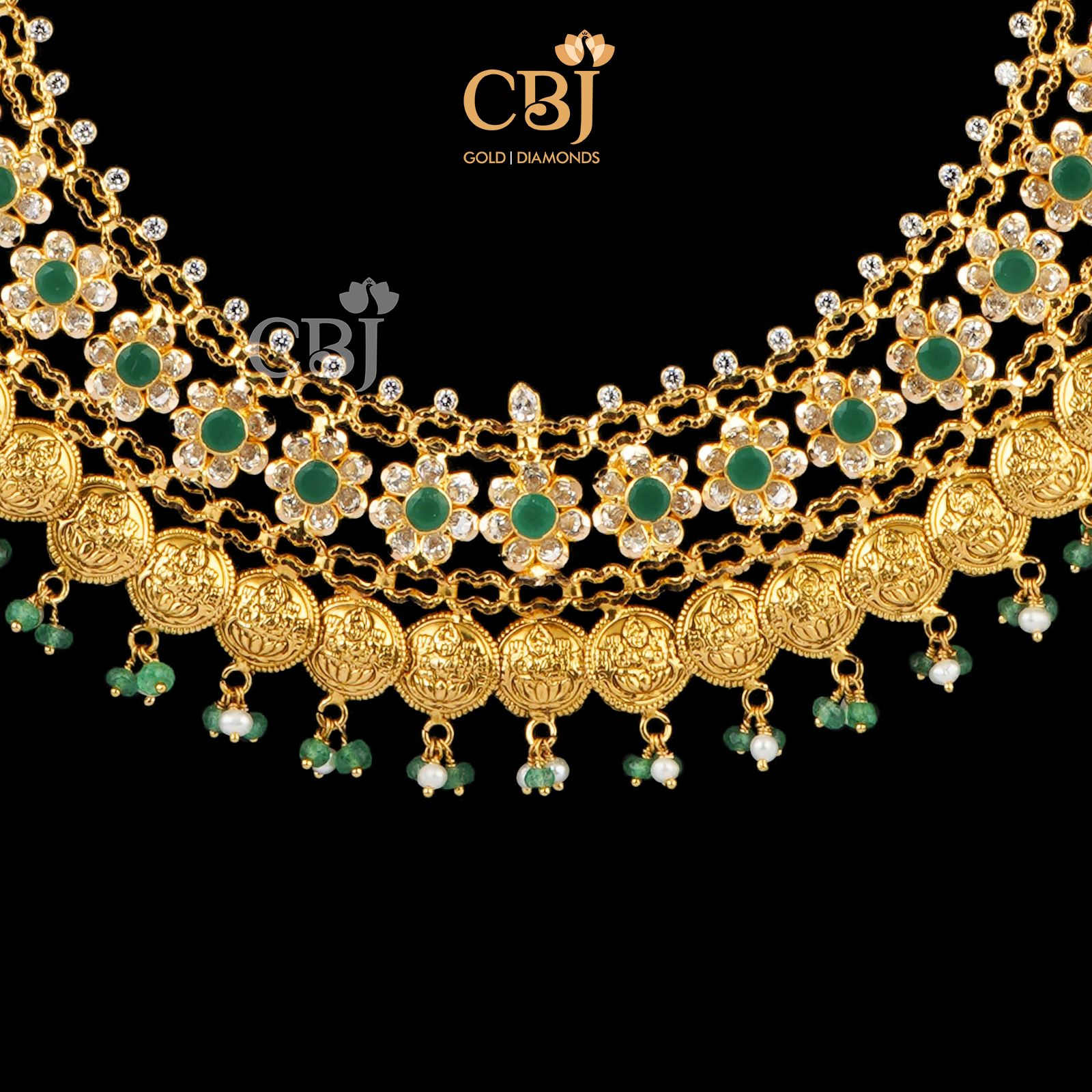 A one of a kind kasu mala beautifully decorated with emerald stones.