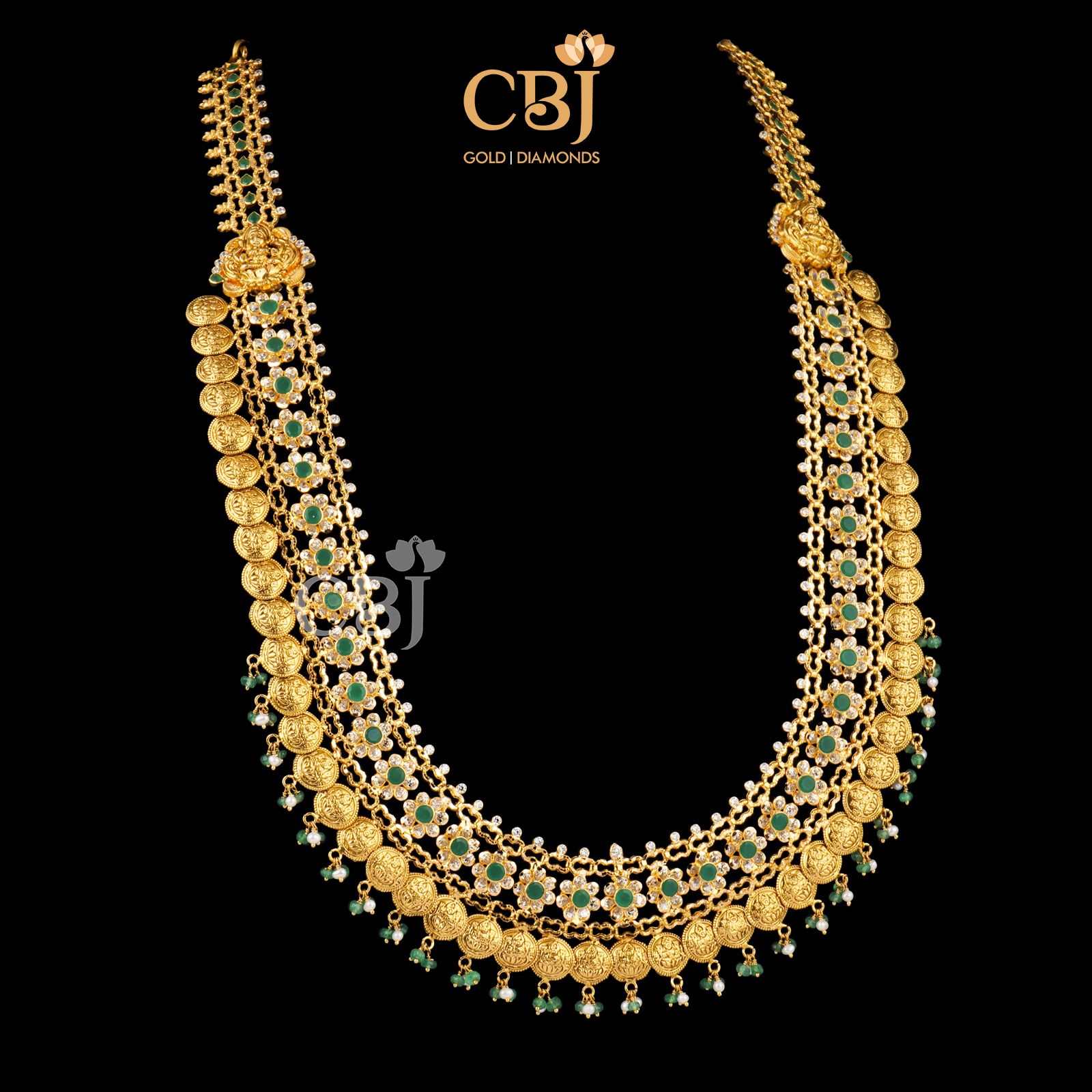 A one of a kind kasu mala beautifully decorated with emerald stones.