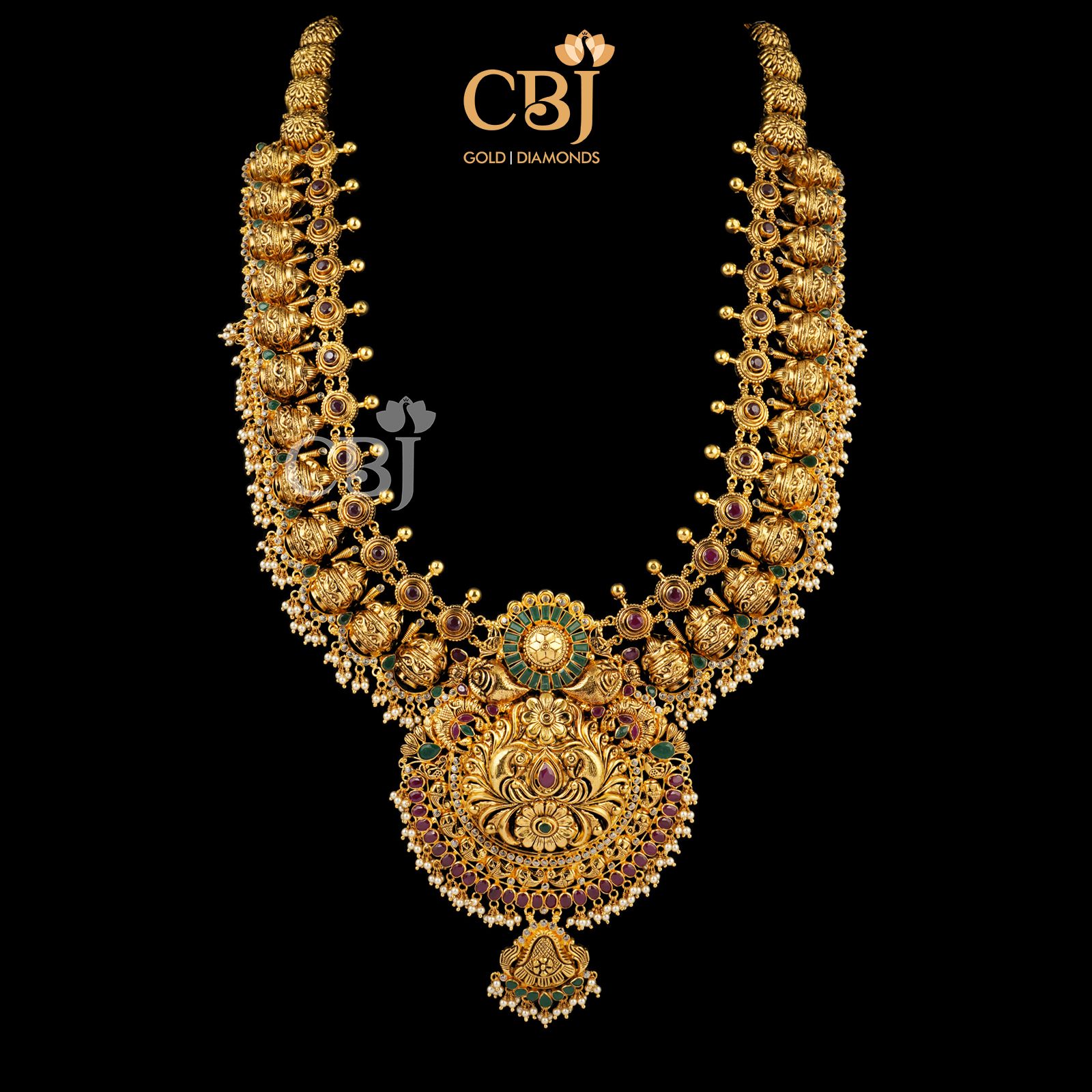 A magnificent 22k U haram featuring rubies, emeralds and micro-pearls. 