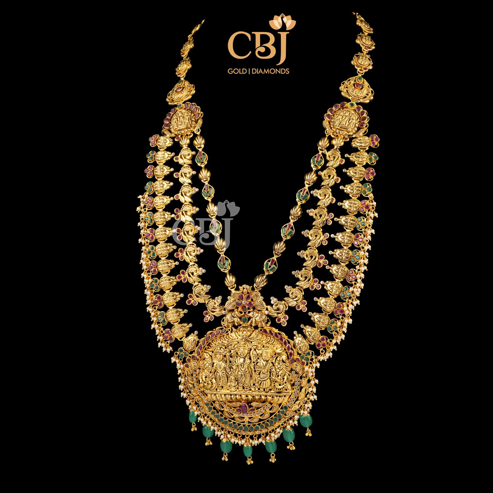 A 3 step long haram with divine motifs featuring rubies and emeralds.