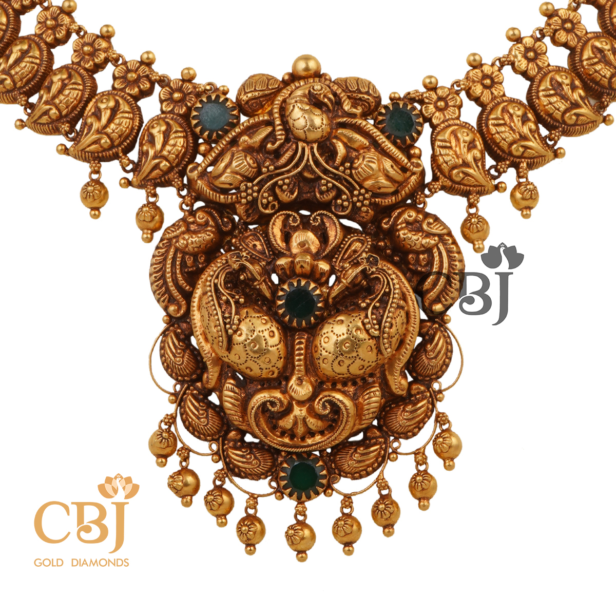 A short antique mango necklace studded with emerald stones.
