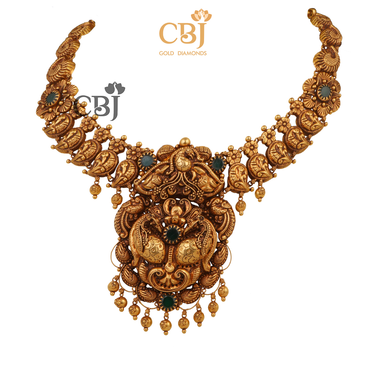 A short antique mango necklace studded with emerald stones.