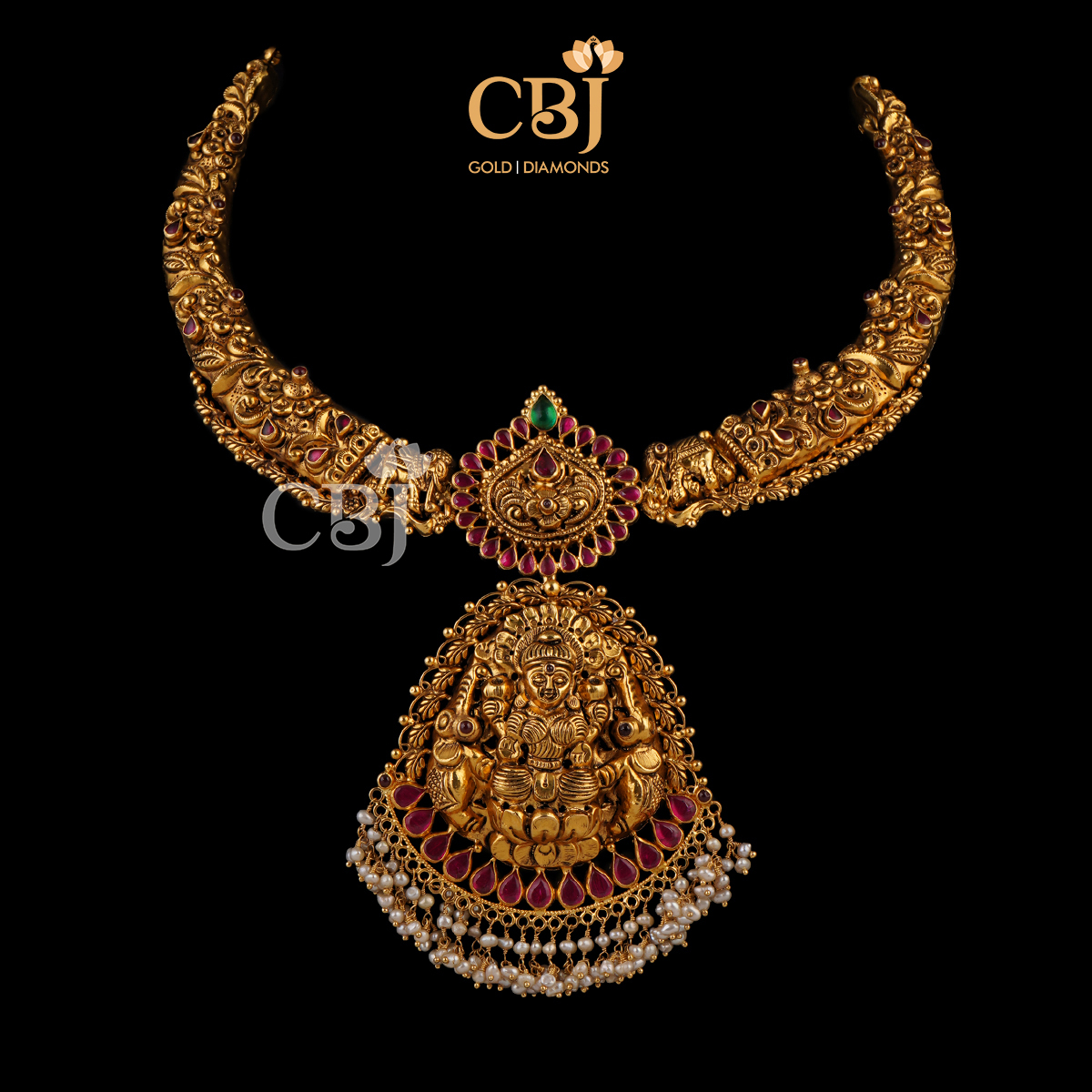 A traditional antique kante studded with ruby stones, suspended with micro pearls.