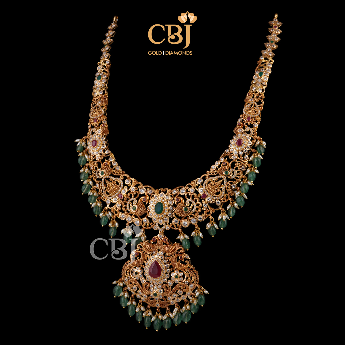 A dazzling designer CZ pachu U haram with emerald drops.