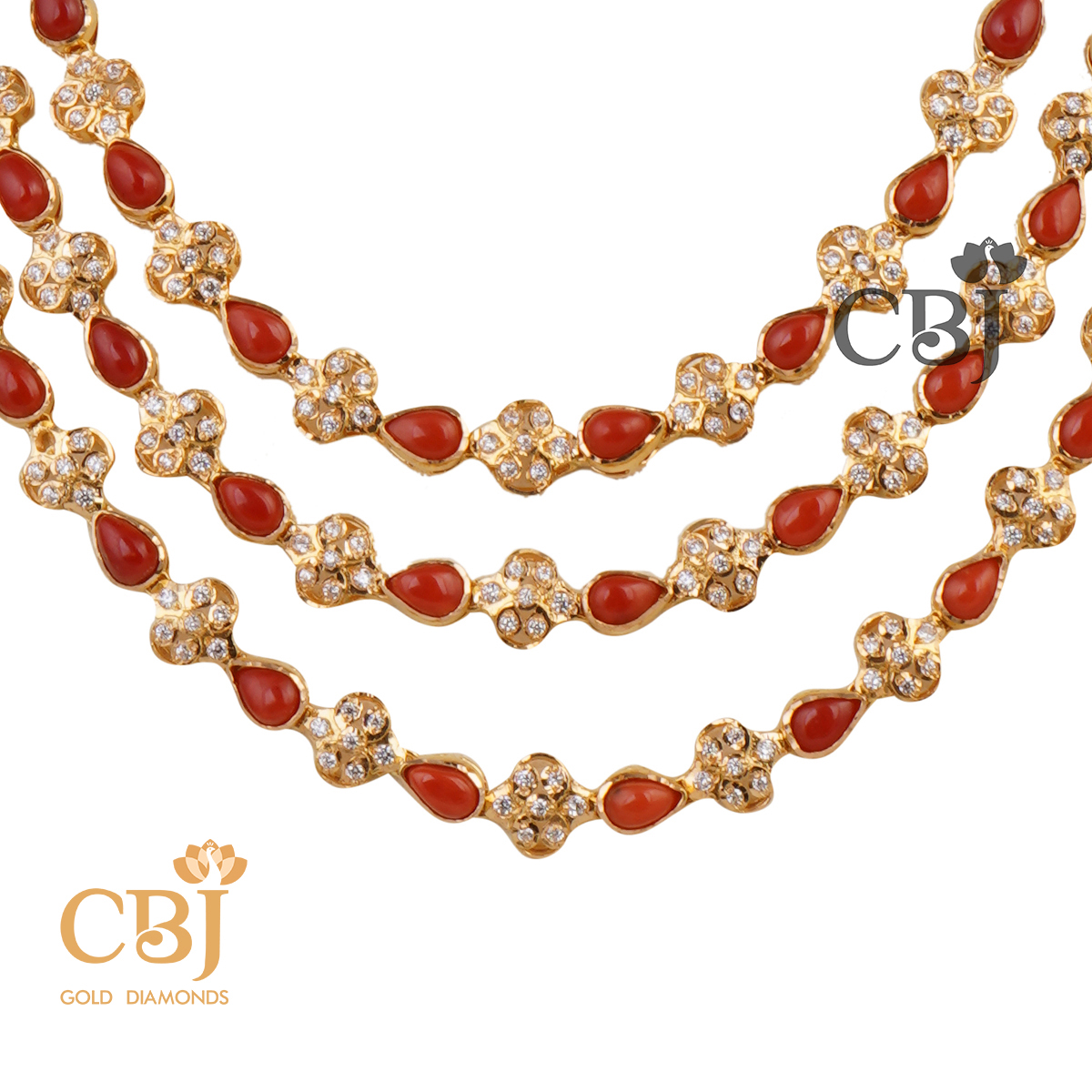 A 3 step CZ haram studded with coral stones in a symmetrical fashion.