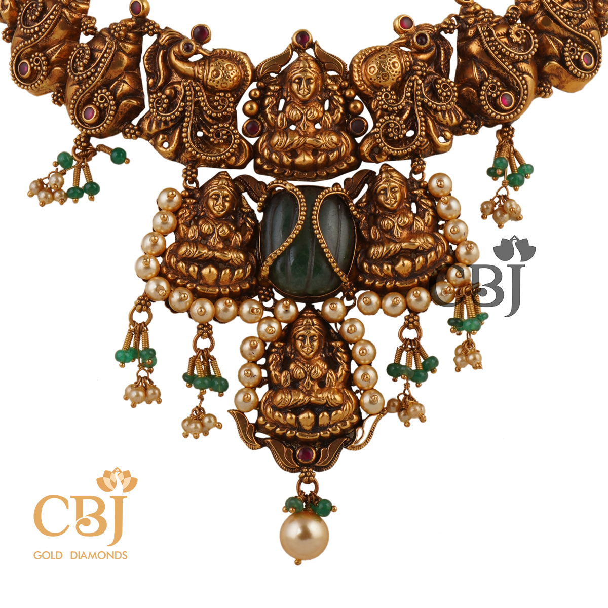 A unique antique nakashi necklace featuring ruby potas and emerald stones.