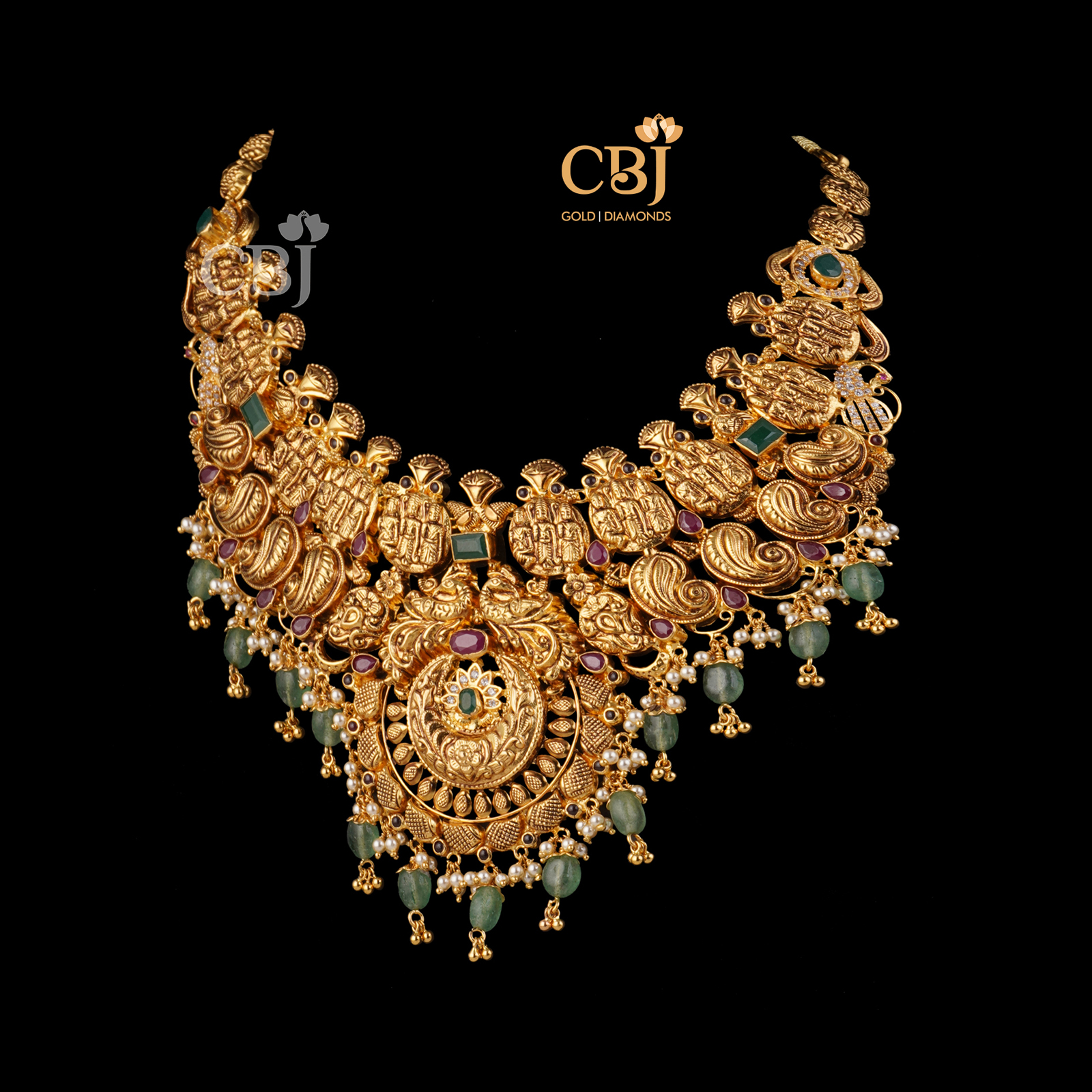 An antique nakashi necklace featuring zambian emeralds.