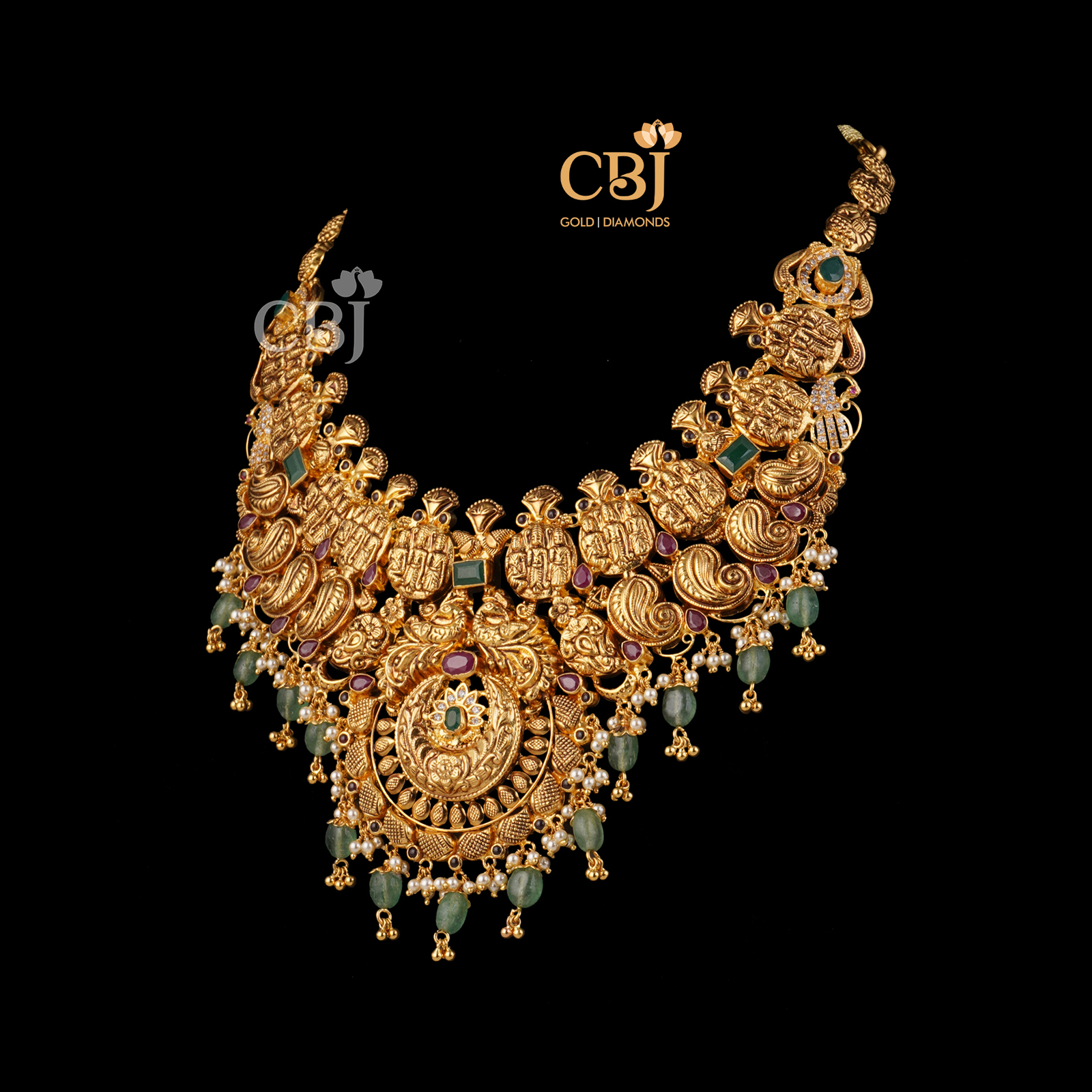 An antique nakashi necklace featuring zambian emeralds.