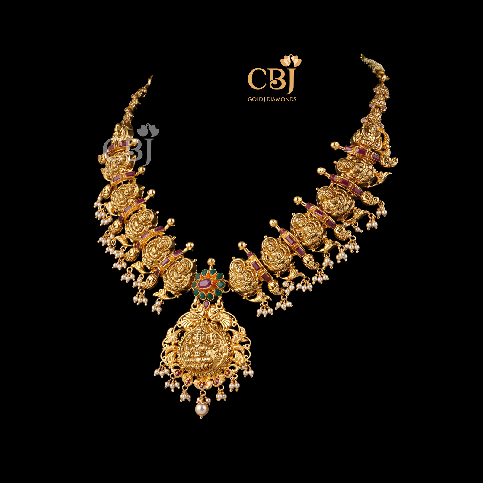 Antique necklace featuring divine motifs decorated with ruby and emerald stones.