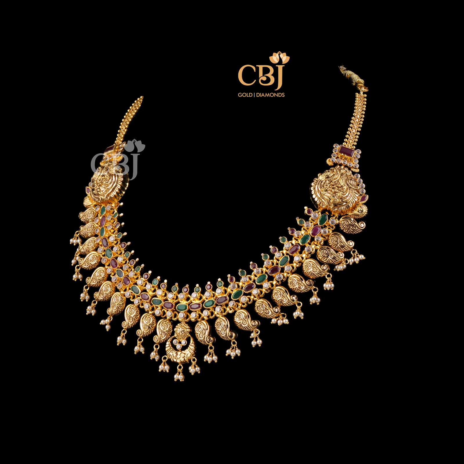 A light weight mango necklace symmetrically designed with ruby and emerald stones.