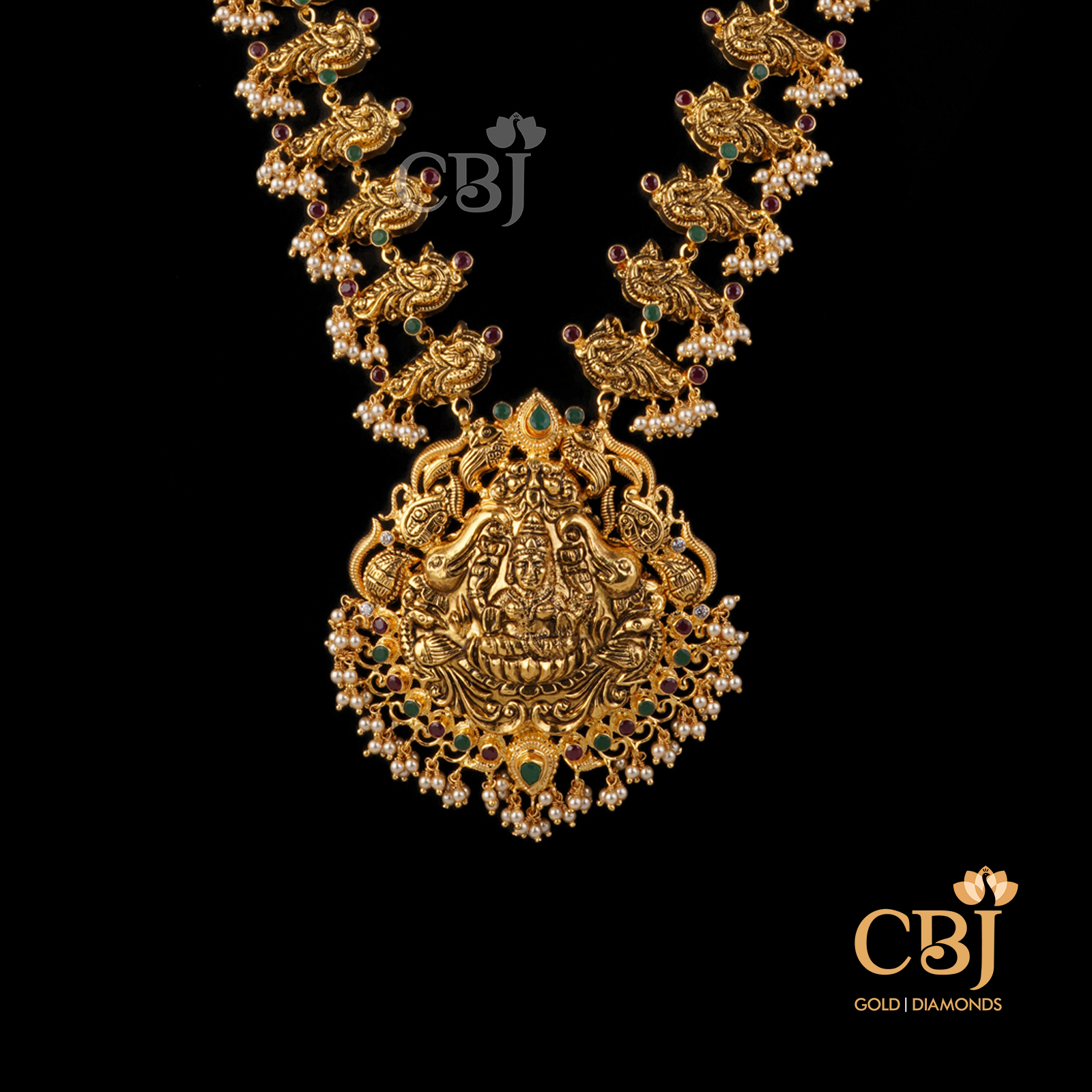 A light weight ruby emerald haram featuring divine motifs.