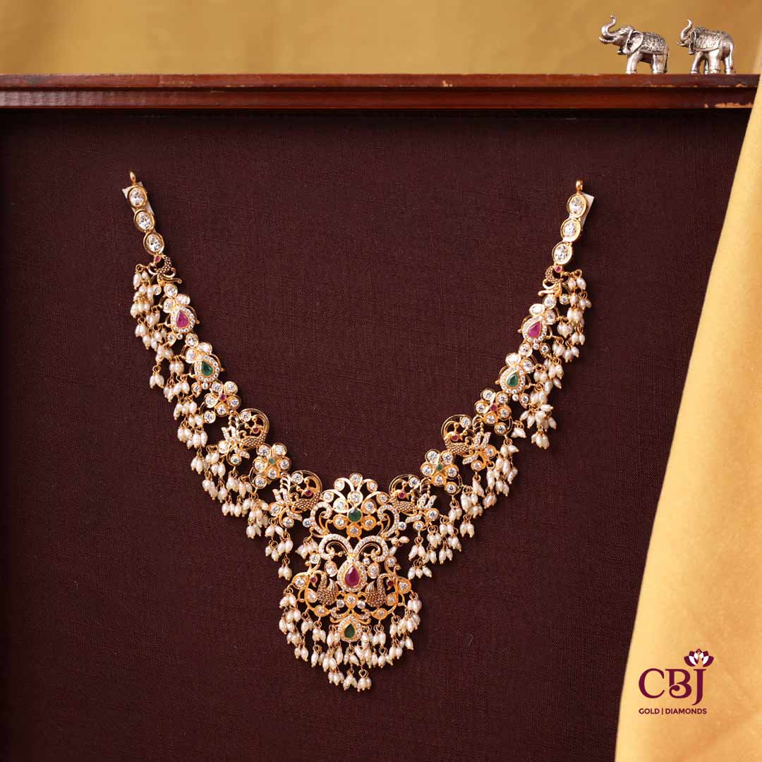 This CZ Pachi necklace is a divine peace of art featuring a beautiful blend of CZs, rubies and emeralds to bring out the diva in you!