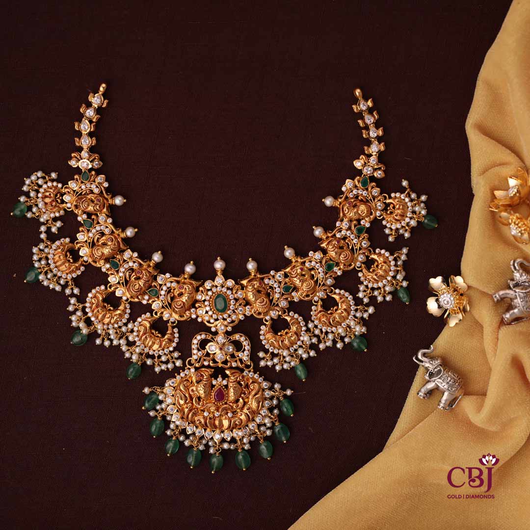 A lustrous designer chand  necklace featuring CZs, pearls and emeralds.