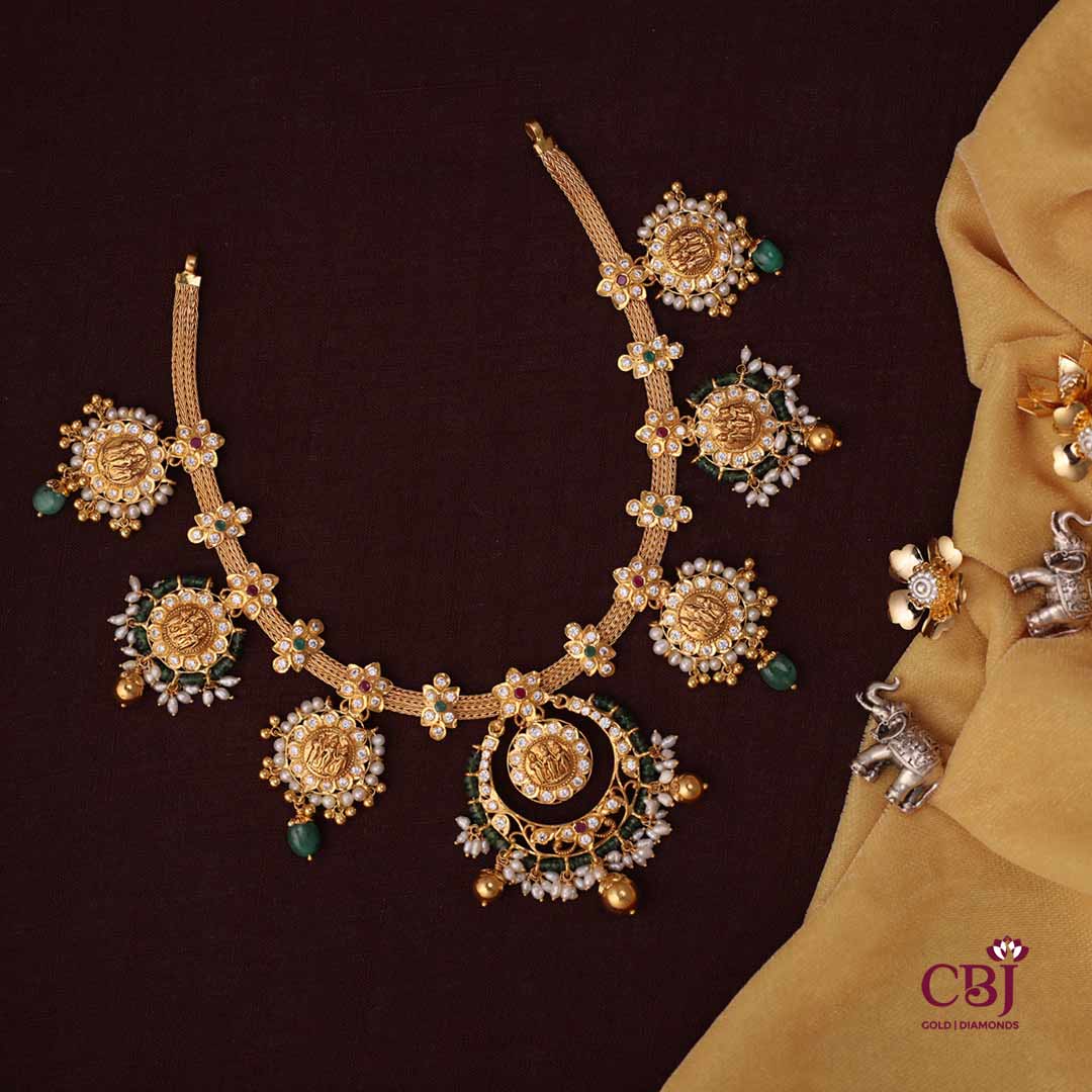A ram parivar necklace adorned with CZs and pearls, featuring an intrinsic one of a kind design.