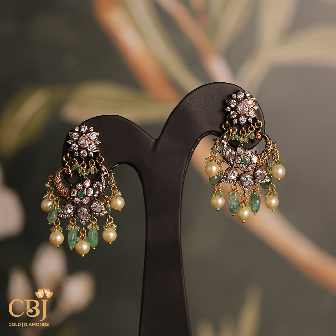 The perfect finishing touch to any outfit - this peacock style earrings featuring CZ, pearls and emeralds is a must have!