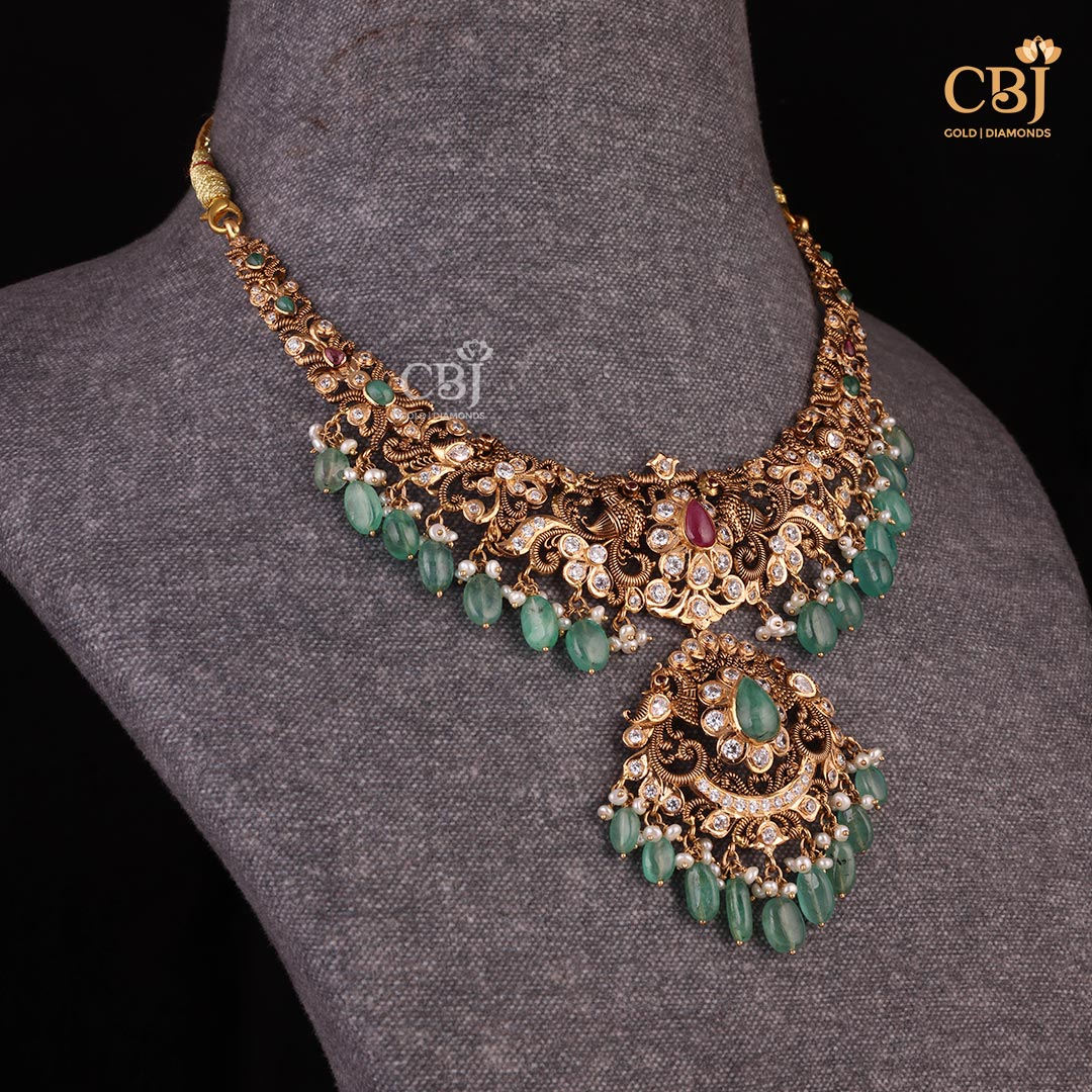 Embrace the pachi charm with this short necklace featuring CZ’s and emerald stones.