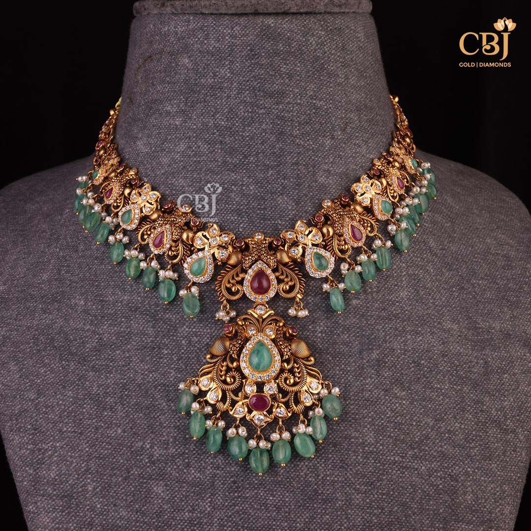 Pachi Jewellery : Where Tradition Meets Timelessness  A drop design short necklace featuring pearls, rubies, emeralds and CZ stones.