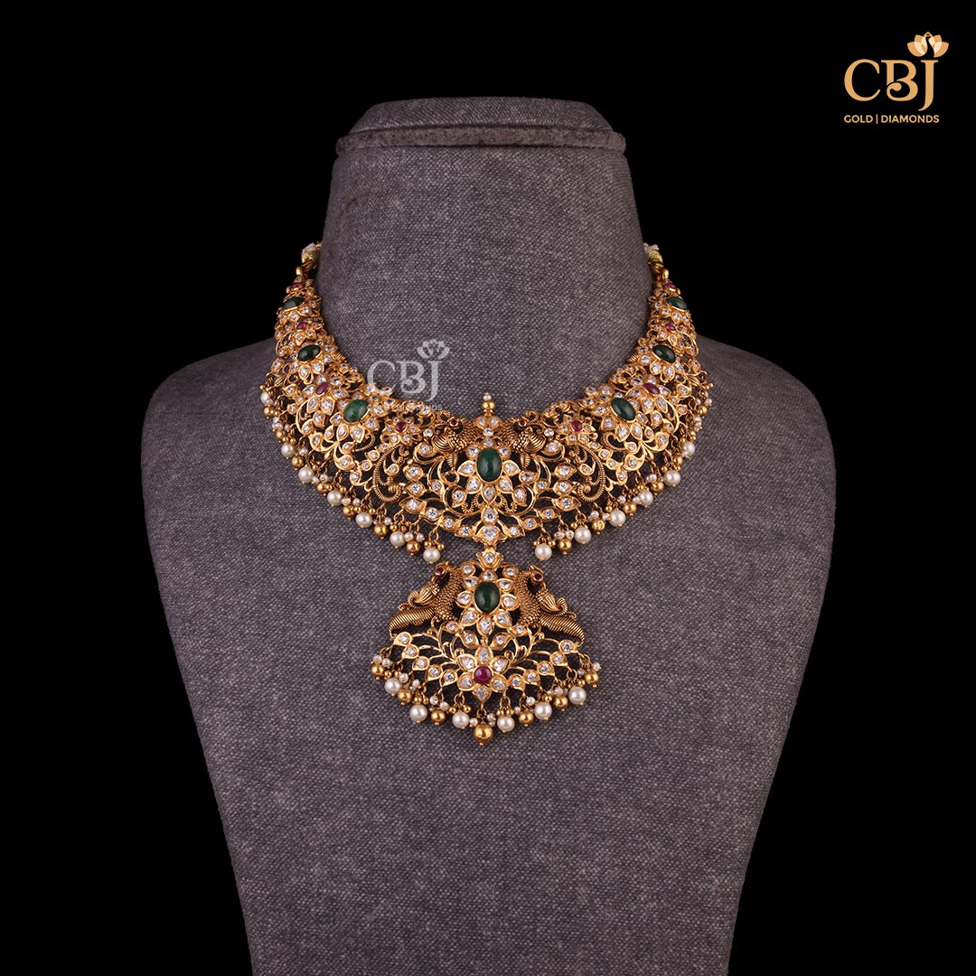 An astounding design that casts a glowing spell in just one glance!  A classic pachi short necklace featuring CZs, pearls and emerald stones.