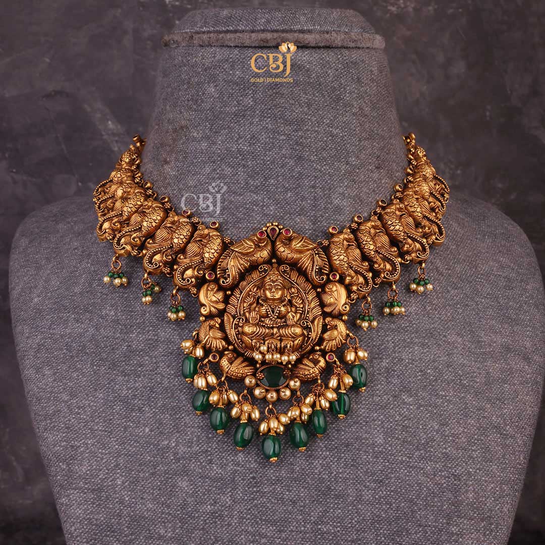 Antique Lakshmi Short Haram featuring peacock motifs decorated with rubies, pearls and emeralds.