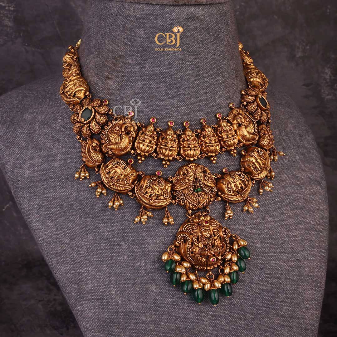 A 2 step antique short necklace featuring Goddess Lakshmi and elephant motifs decorated with pearls