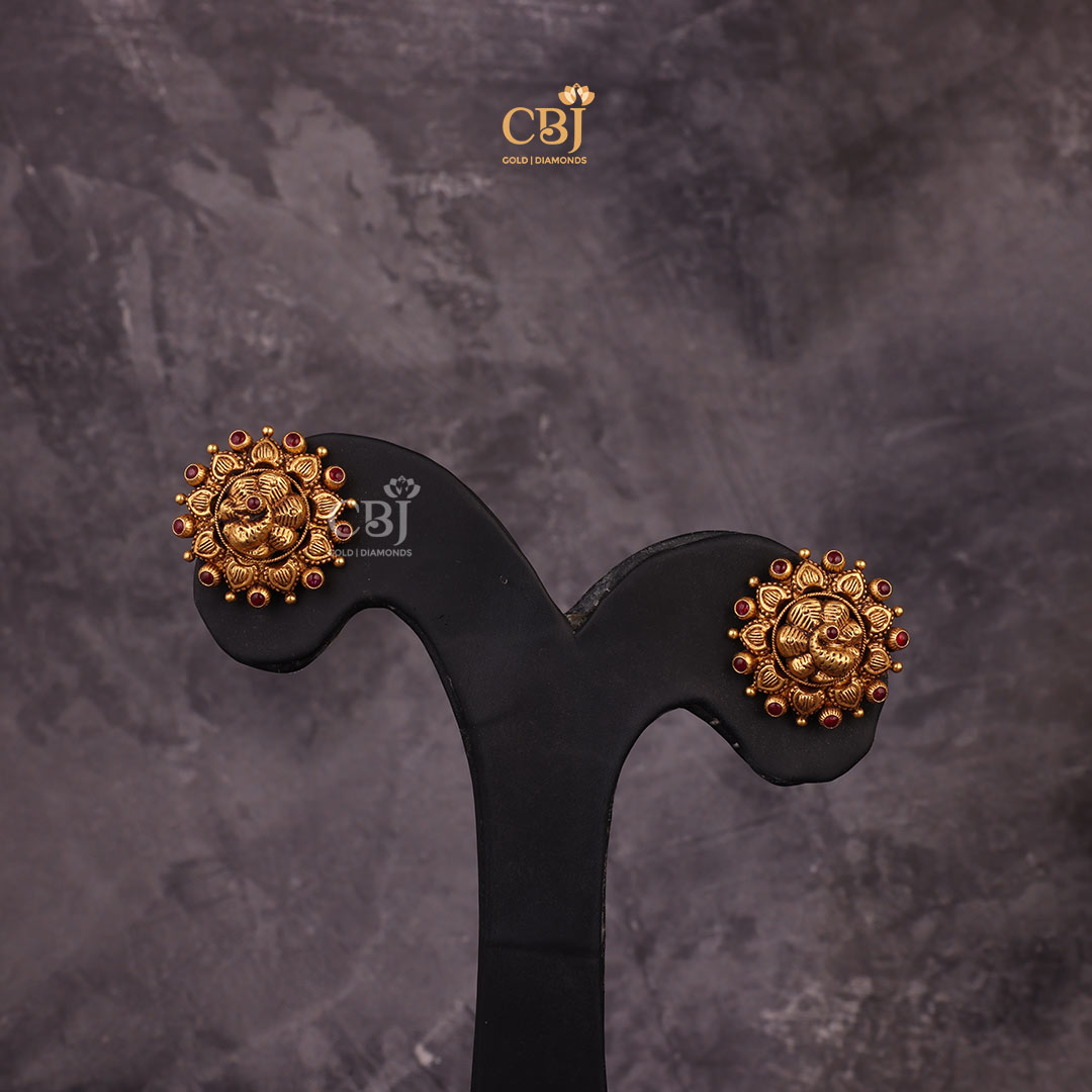 Experience Intricate Artistry with these stunning pair of antique studs featuring peacock motifs decorated with ruby potas.