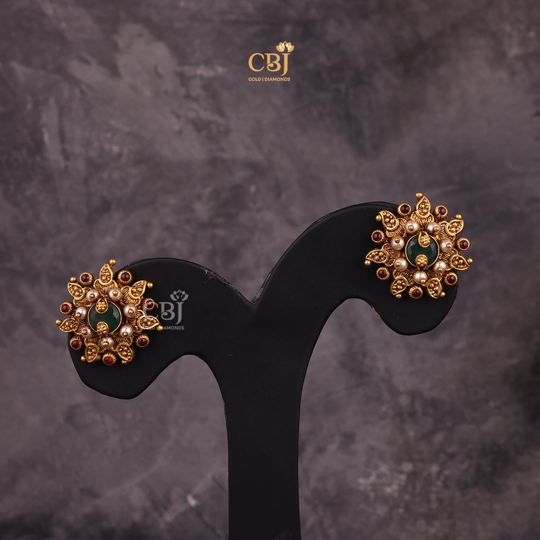 Antique studs paired with a culmination of stones like emerald, rubies and pearls.