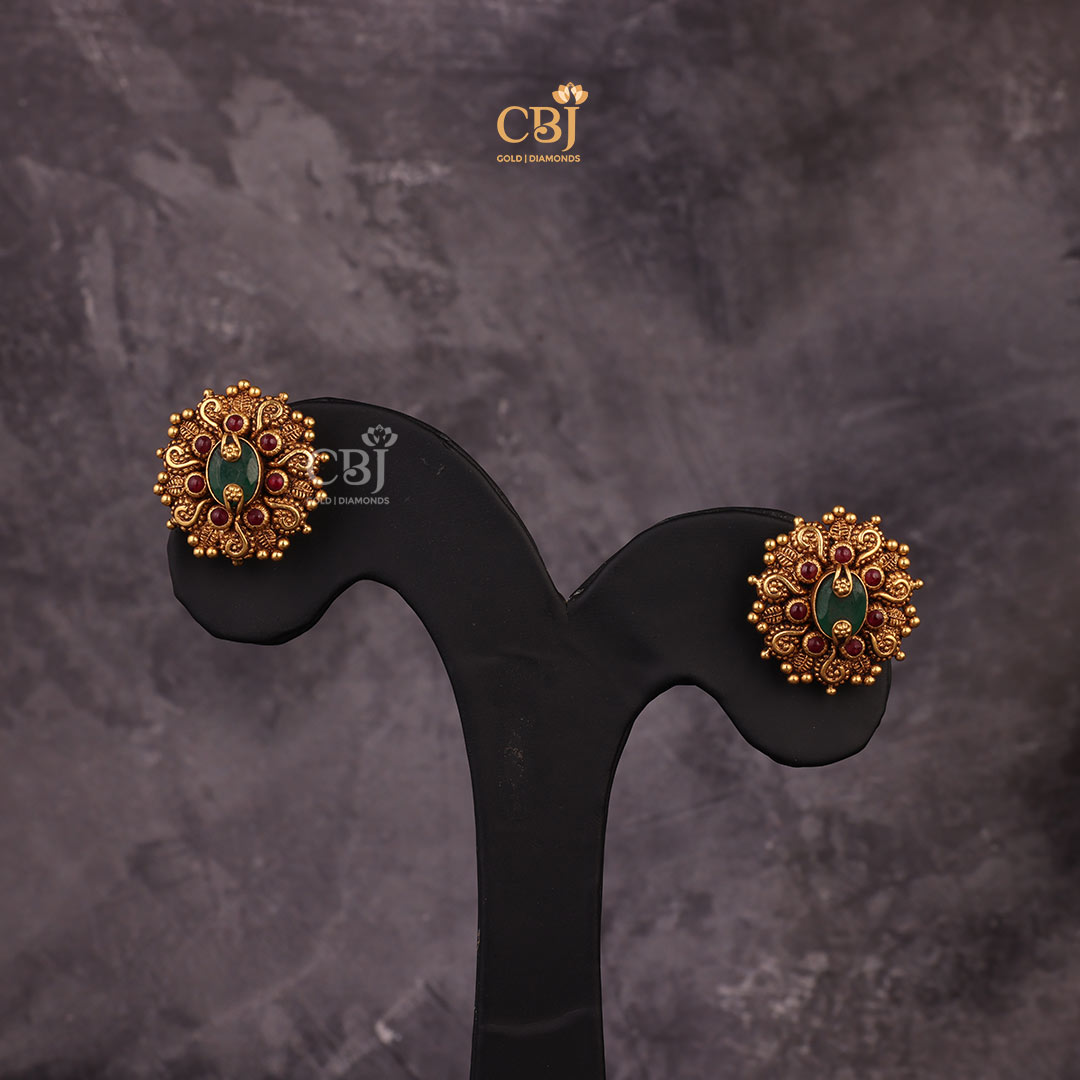 Antique Emerald Studs decorated with leaf like motifs.