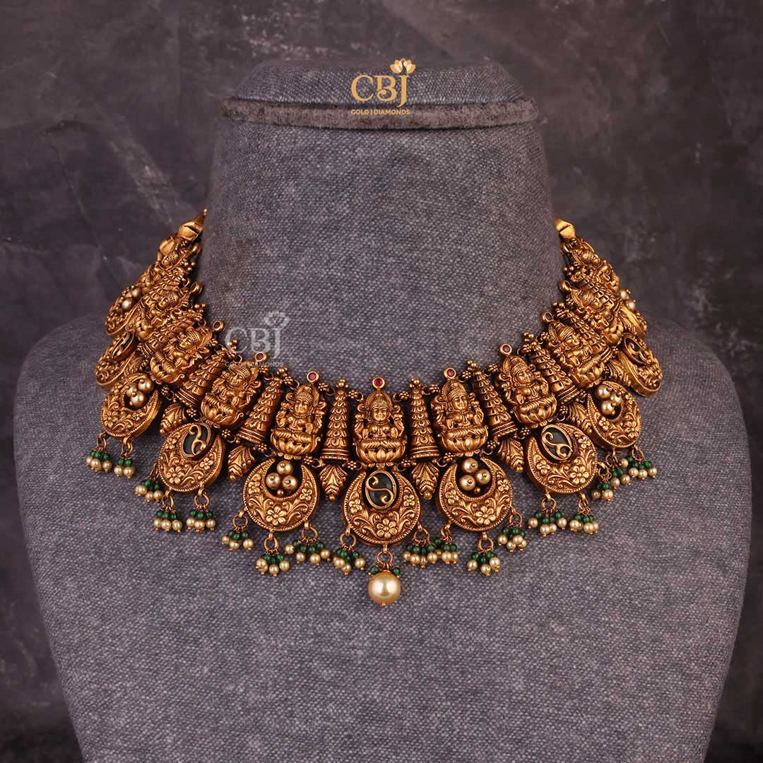An antique Lakshmi haram accompanied by fine crescent shaped motifs.