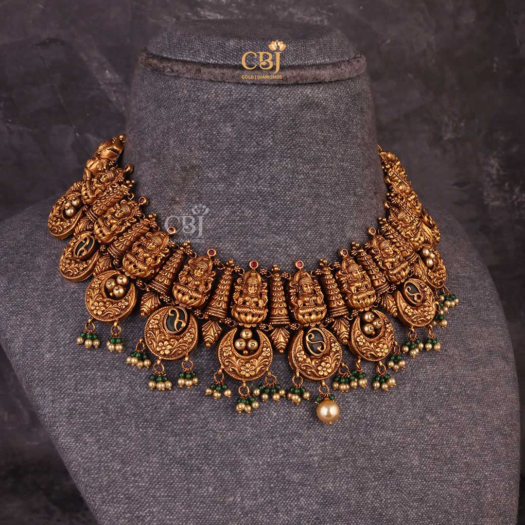 An antique Lakshmi haram accompanied by fine crescent shaped motifs.