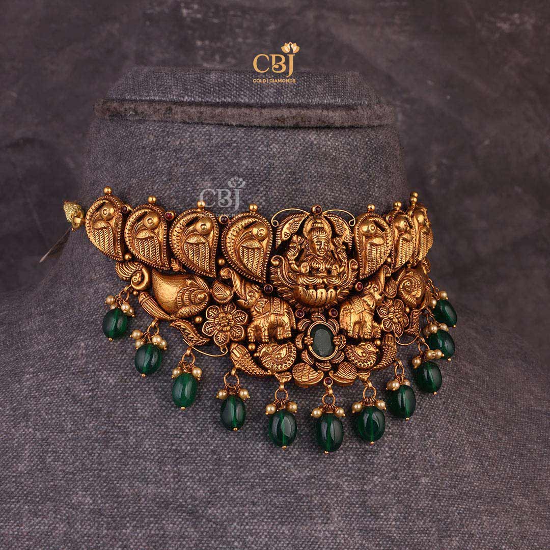 Antique Gajalakshmi featuring swan and elephant motifs embellished with pearls and emeralds.