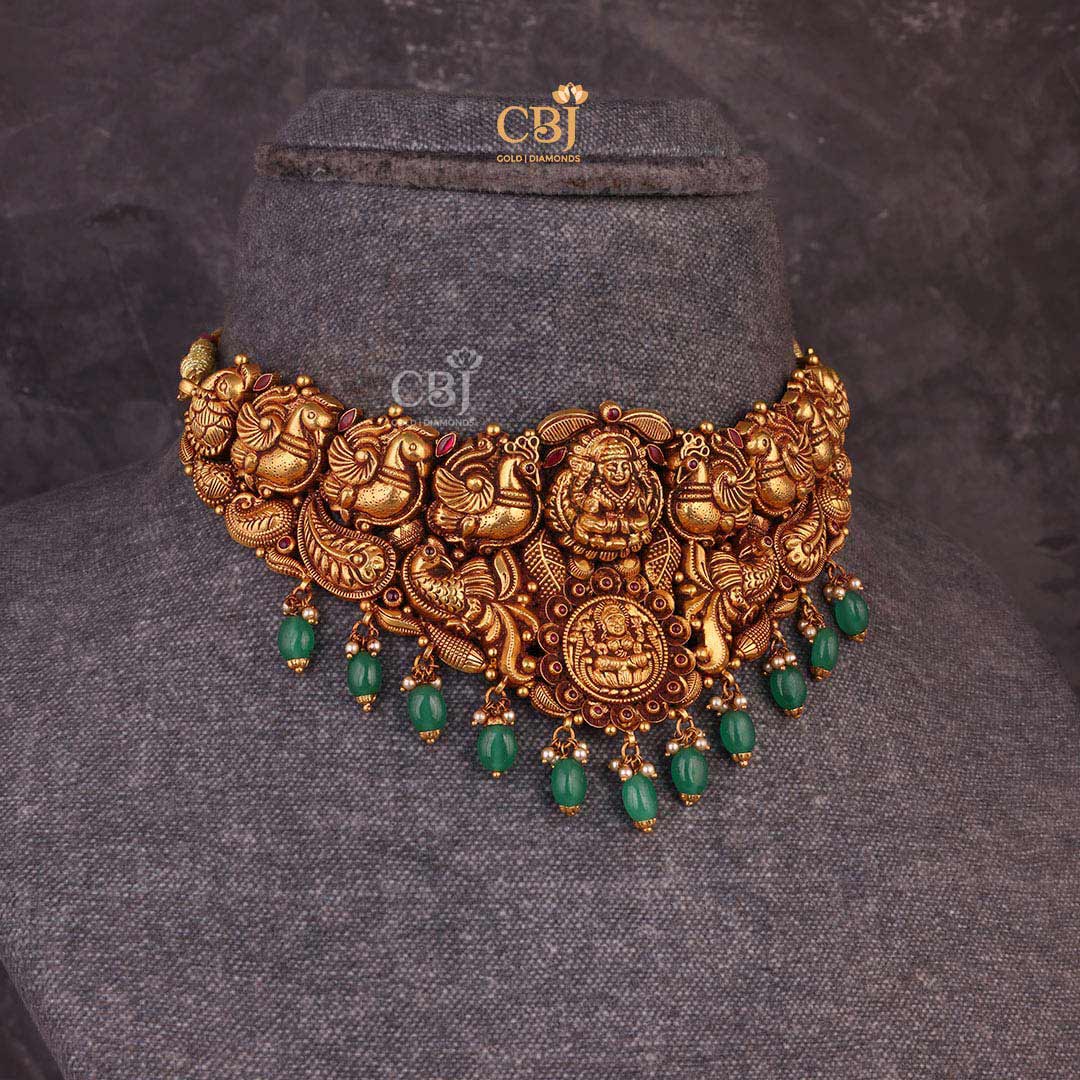 Embrace the Goddess of wealth with this stunning antique choker studded with emerald stones.
