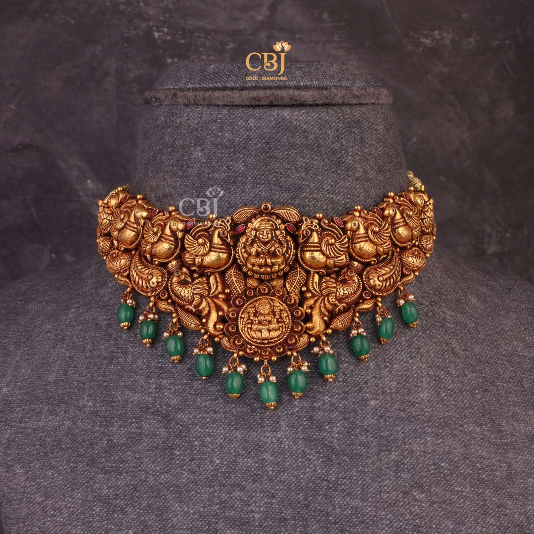 Embrace the Goddess of wealth with this stunning antique choker studded with emerald stones.