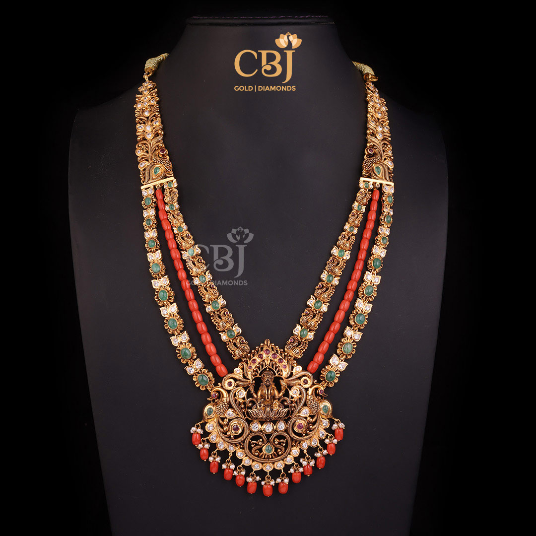 A regal 3 step CZ Pachi long haram embellished with corals, emeralds and pearls.