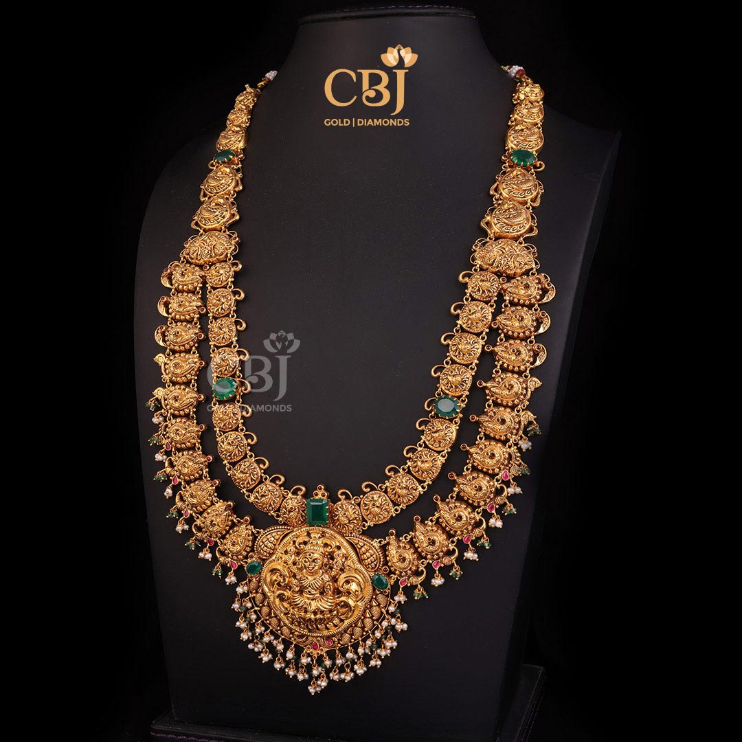 A 2 step antique Lakshmi haram featuring a graceful design decorated with rubies