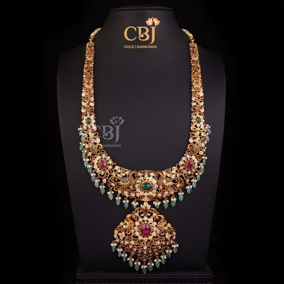 A CZ Pachi long U haram featuring an elaborate design decorated with rubies, emeralds and pearls.