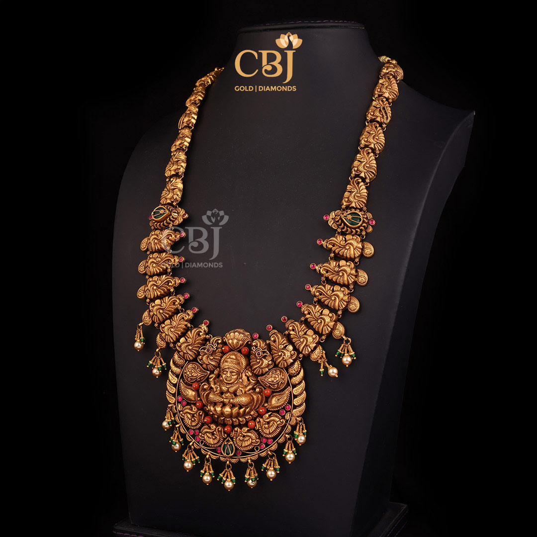 A statement antique Lakshmi long haram embellished with emeralds