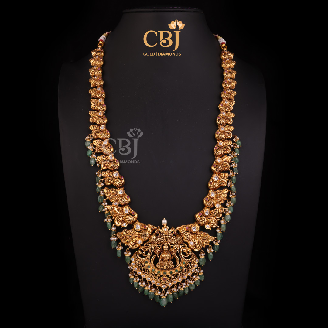 An artistic Lakshmi long haram featuring an antique finish.