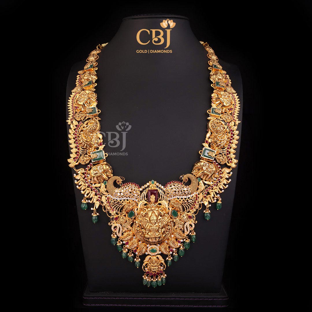 An opulent CZ Pachi Lakshmi light weight haram featuring rubies, emeralds and pearls.