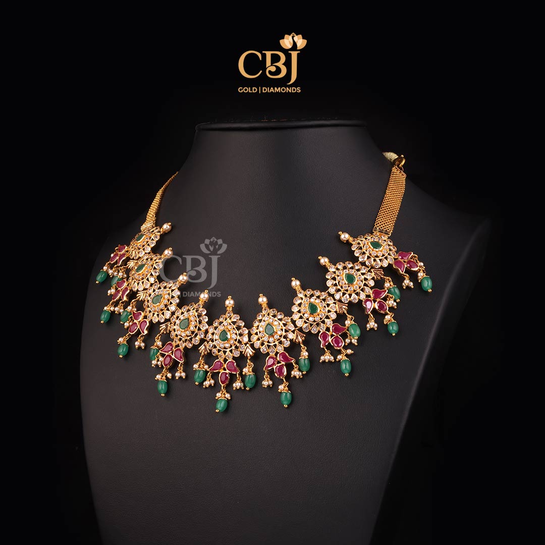 A magnificently crafted glistening short necklace featuring stones like rubies and emeralds.
