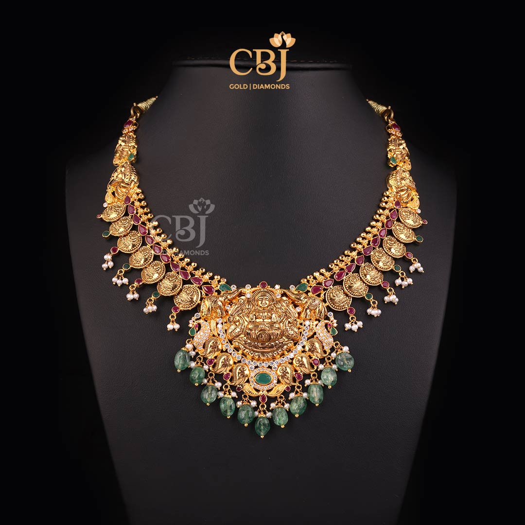 A lightweight Lakshmi Kasumala with an enriching design featuring CZ, rubies, pearls and emeralds.